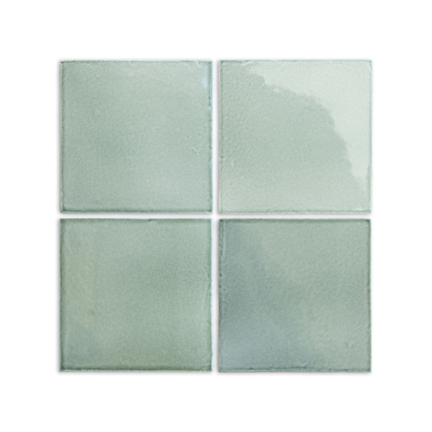 Four 6x6 arctic gloss tiles by Clay Imports, showing subtle color variations and a handcrafted look.