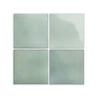 Four 6x6 arctic gloss tiles by Clay Imports, showing subtle color variations and a handcrafted look.