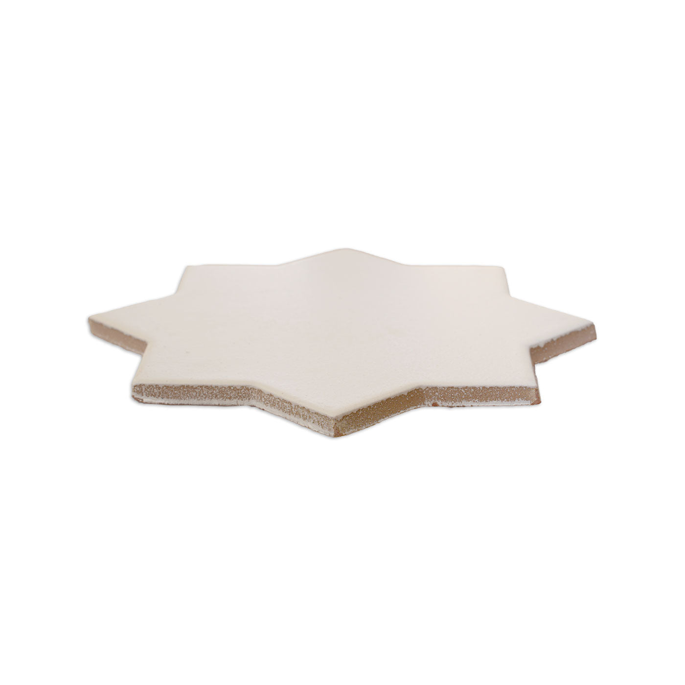 Vanilla 8-point star solid tile by Clay Imports with smooth matte surface and rough edges.