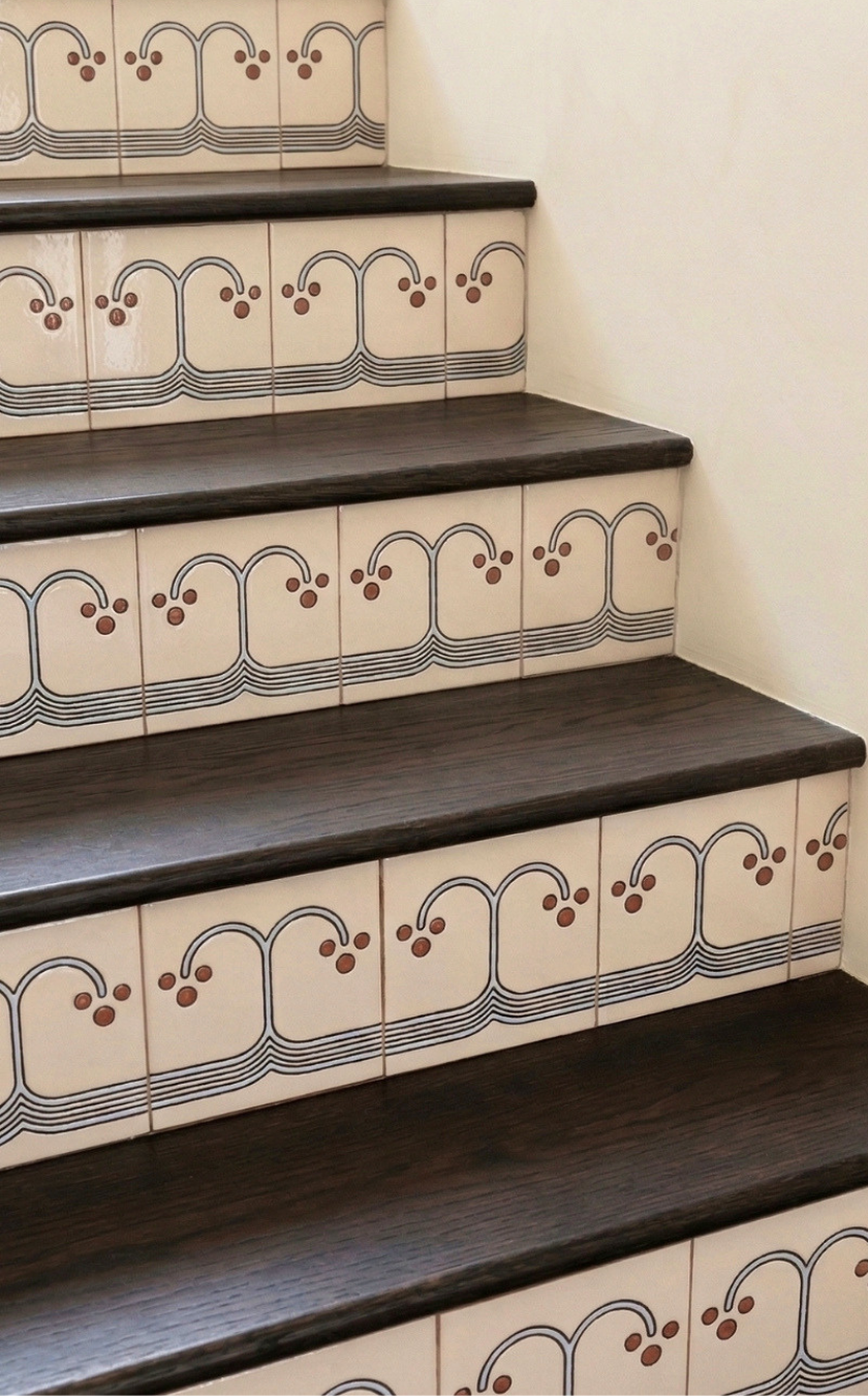 Staircase with decorative tiles on a plain background