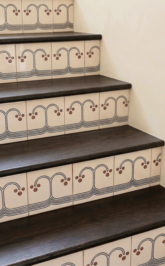 Staircase with decorative tiles on a plain background