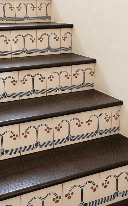 Staircase with decorative tiles on a plain background