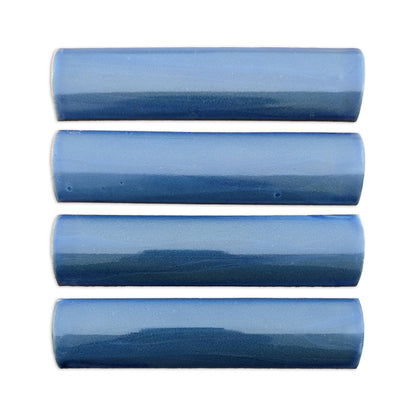 Four blue glazed Stardust quarter round tiles by Clay Imports, with a glossy, light to dark blue gradient.