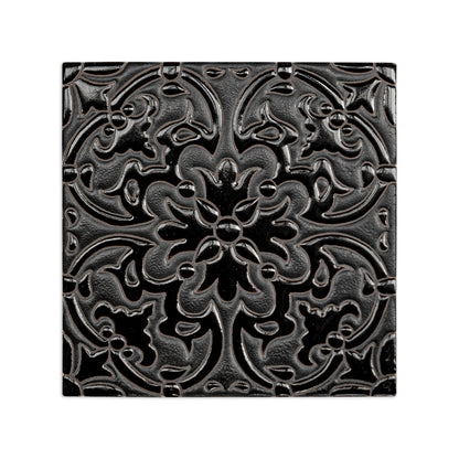 Black relief tile with intricate floral and scroll pattern, glossy finish, 6x6 inch square, front view
