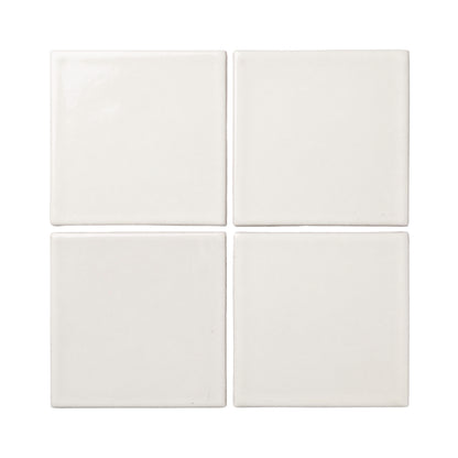 Four off-white square clay tiles by Clay Imports, arranged in a grid with smooth, varied textures.