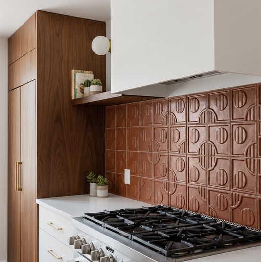Terra cotta geometric tiles by Clay Imports in a kitchen backsplash, featuring a circular and linear embossed pattern.