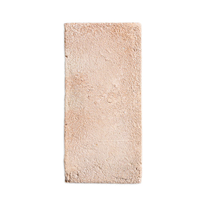 A rectangular, light beige textured rug with a shaggy, plush pile, shown flat against a solid white background.