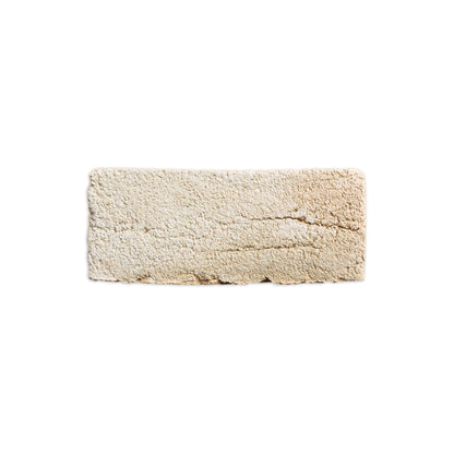 A rectangular beige textured rug with a shaggy, looped pile, shown flat against a solid white background.
