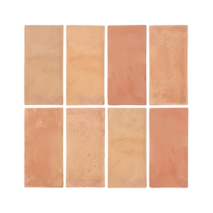 Eight rectangular terracotta tiles arranged in a 2x4 grid on a plain white background, showing variations in warm peach, orange, and sandy beige tones.
