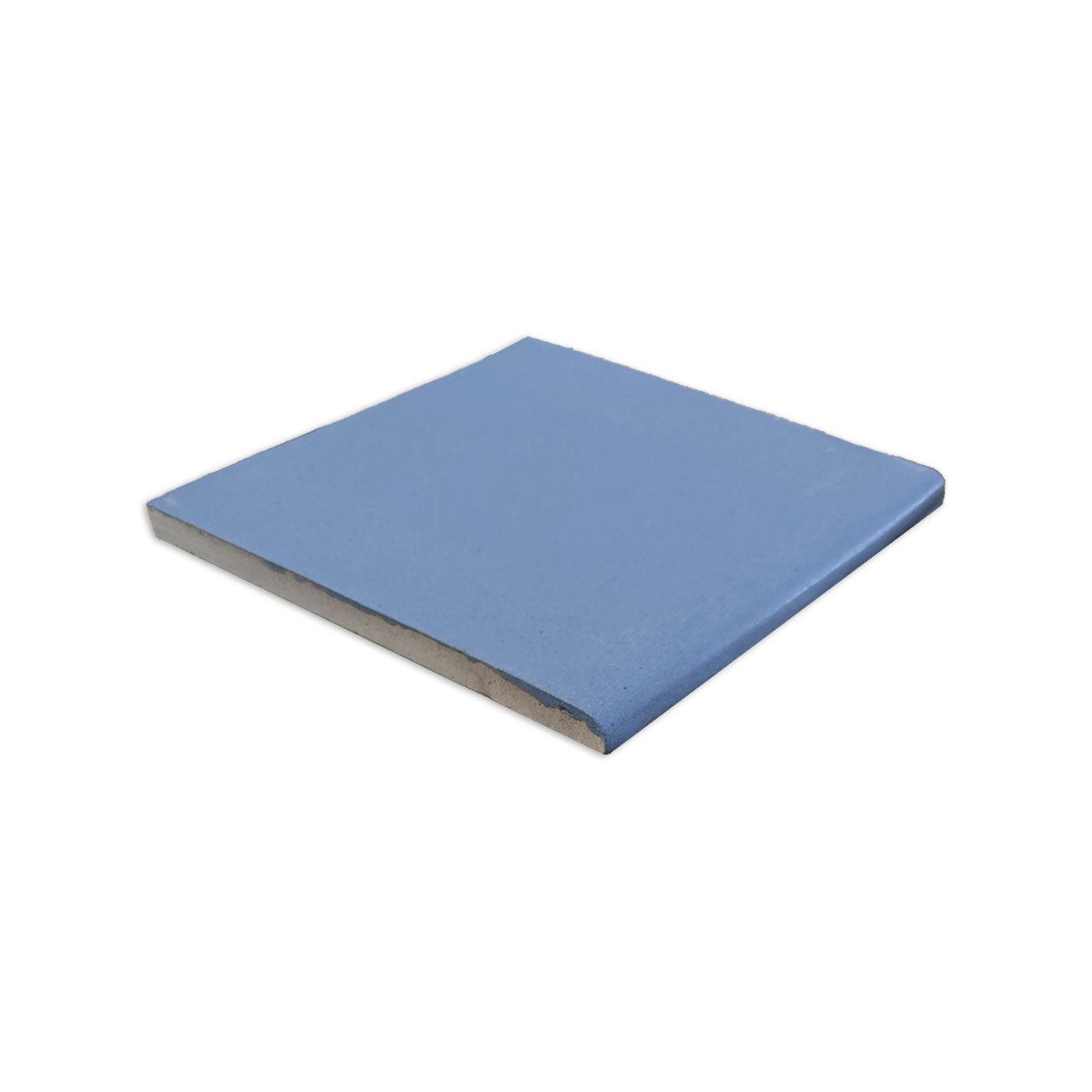 Single bullnose denim blue matte tile by Clay Imports, angled view showing its rounded edge and unglazed side.