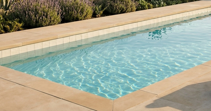 Glazed Cotto Champagne 6x6 Pool Waterline Tile by Clay Imports, lining a pool with clear blue water and light tan deck.