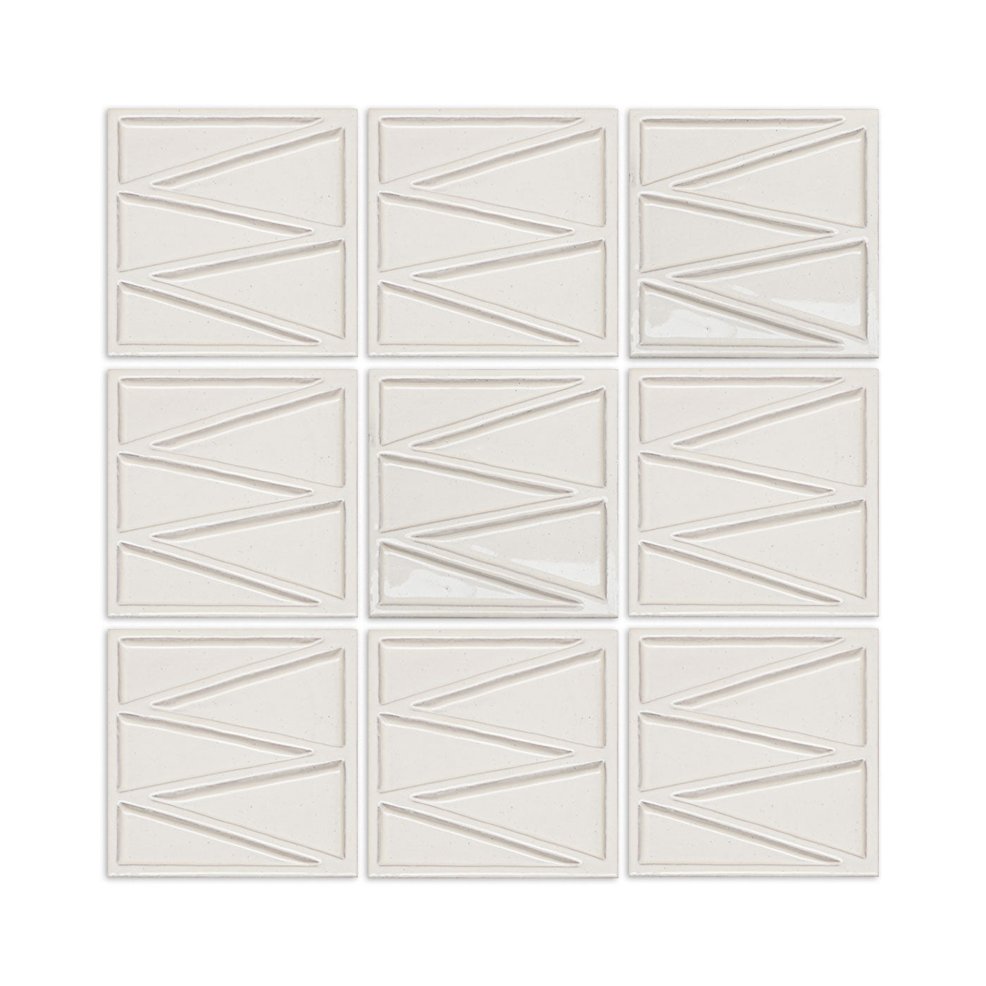 Cream solid tile by Clay Imports with an embossed zigzag geometric pattern in a 3x3 grid.