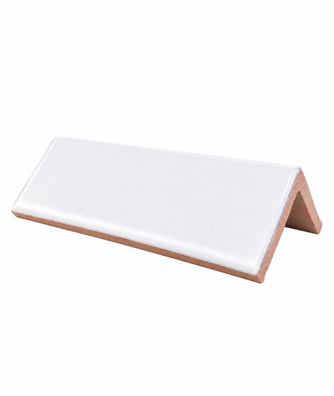 A single L-shaped white ceramic tile rests against a plain white background, showcasing its glossy glazed surface and terracotta base.