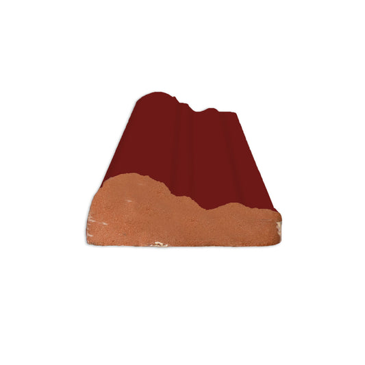 Oxblood chair rail tile trim by Clay Imports, with a glazed top and unglazed terracotta base.