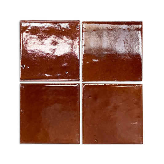 Four glossy Root Beer 6x6 clay tiles by Clay Imports, featuring a rich reddish-brown hue and handmade texture.