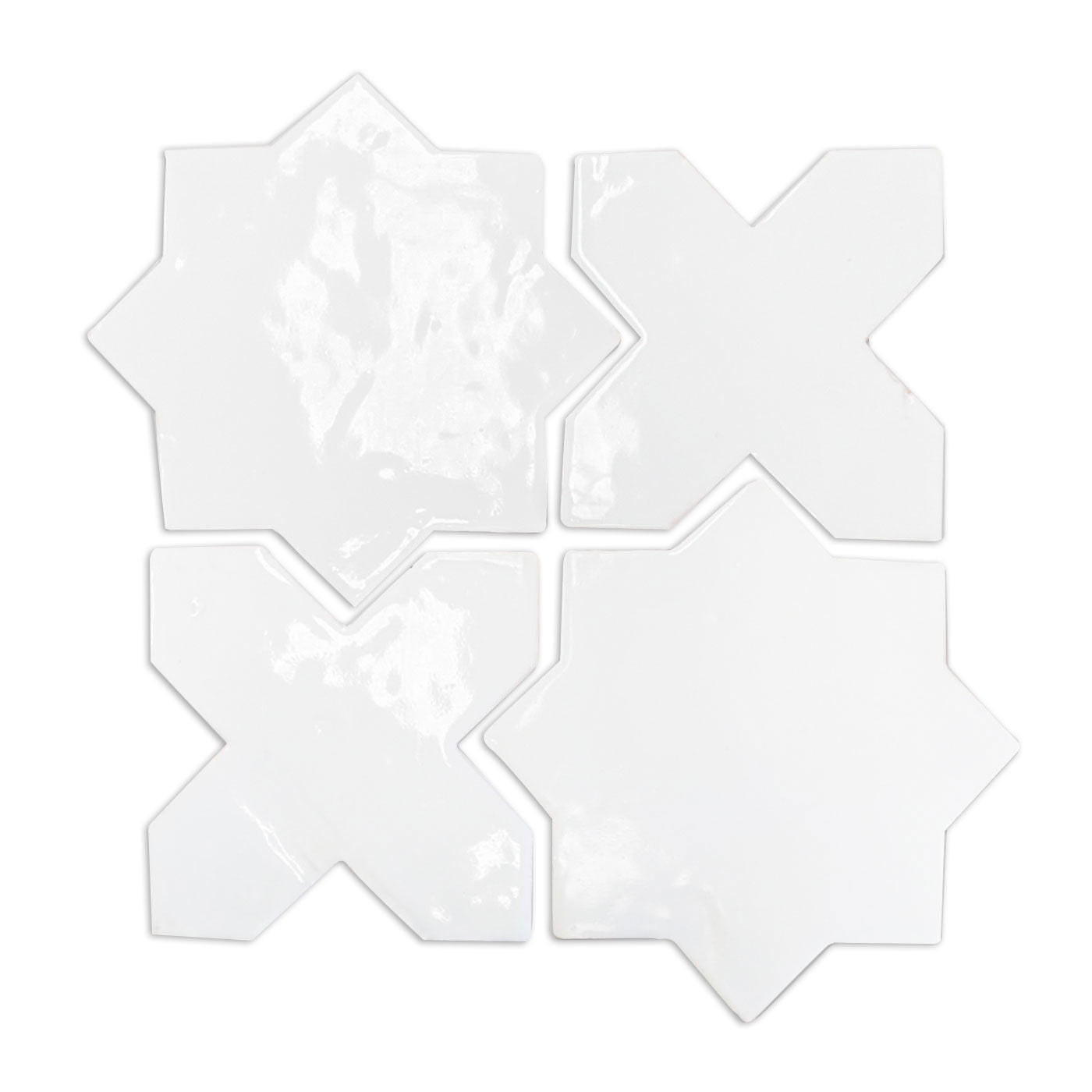 White gloss glazed terracotta star and cross tiles by Clay Imports, arranged in a grid, showing their irregular, glossy surface.