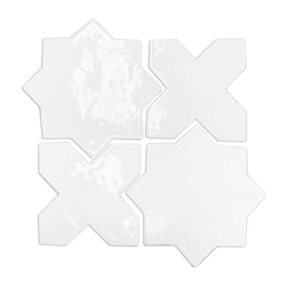 White gloss glazed terracotta star and cross tiles by Clay Imports, arranged in a grid, showing their irregular, glossy surface.