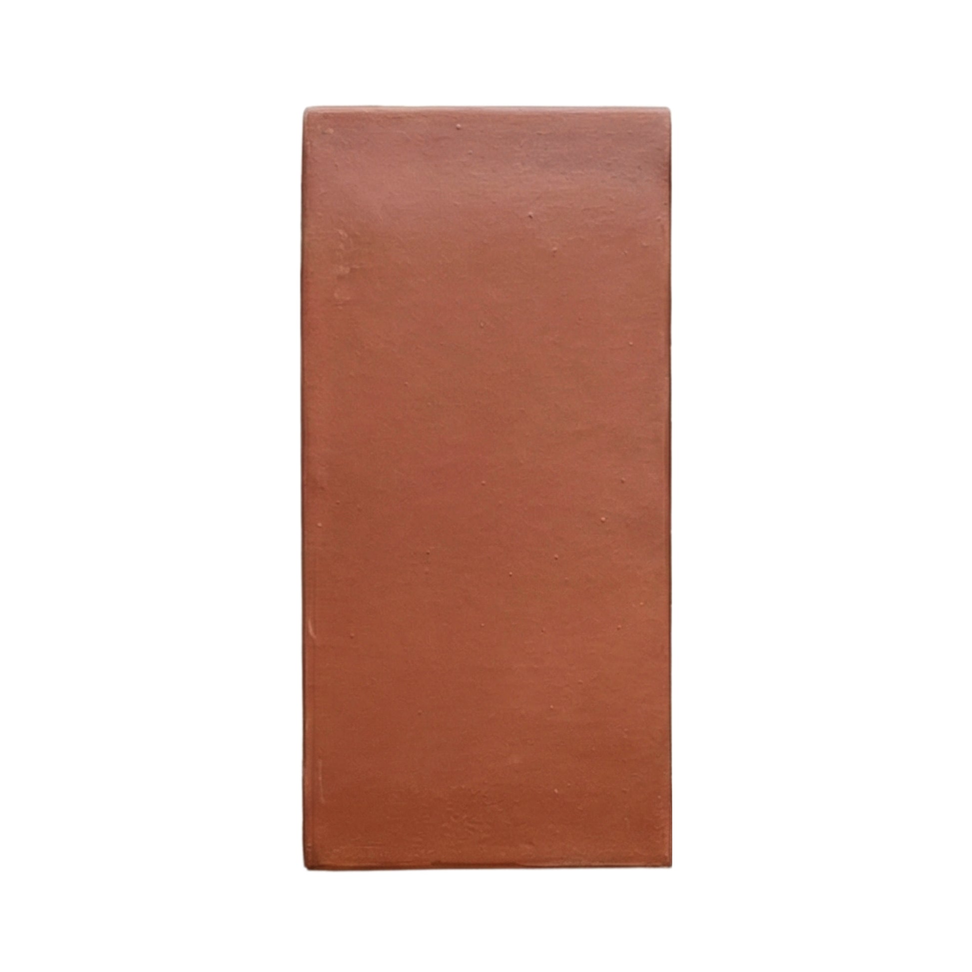 D'Hanis Red 6x12 terracotta sample by Clay Imports, a rectangular tile with a smooth, matte finish and subtle imperfections.