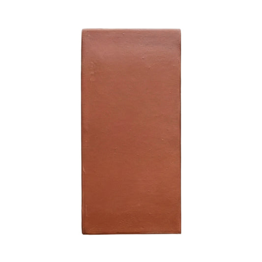 D'Hanis Red 6x12 terracotta sample by Clay Imports, a rectangular tile with a smooth, matte finish and subtle imperfections.
