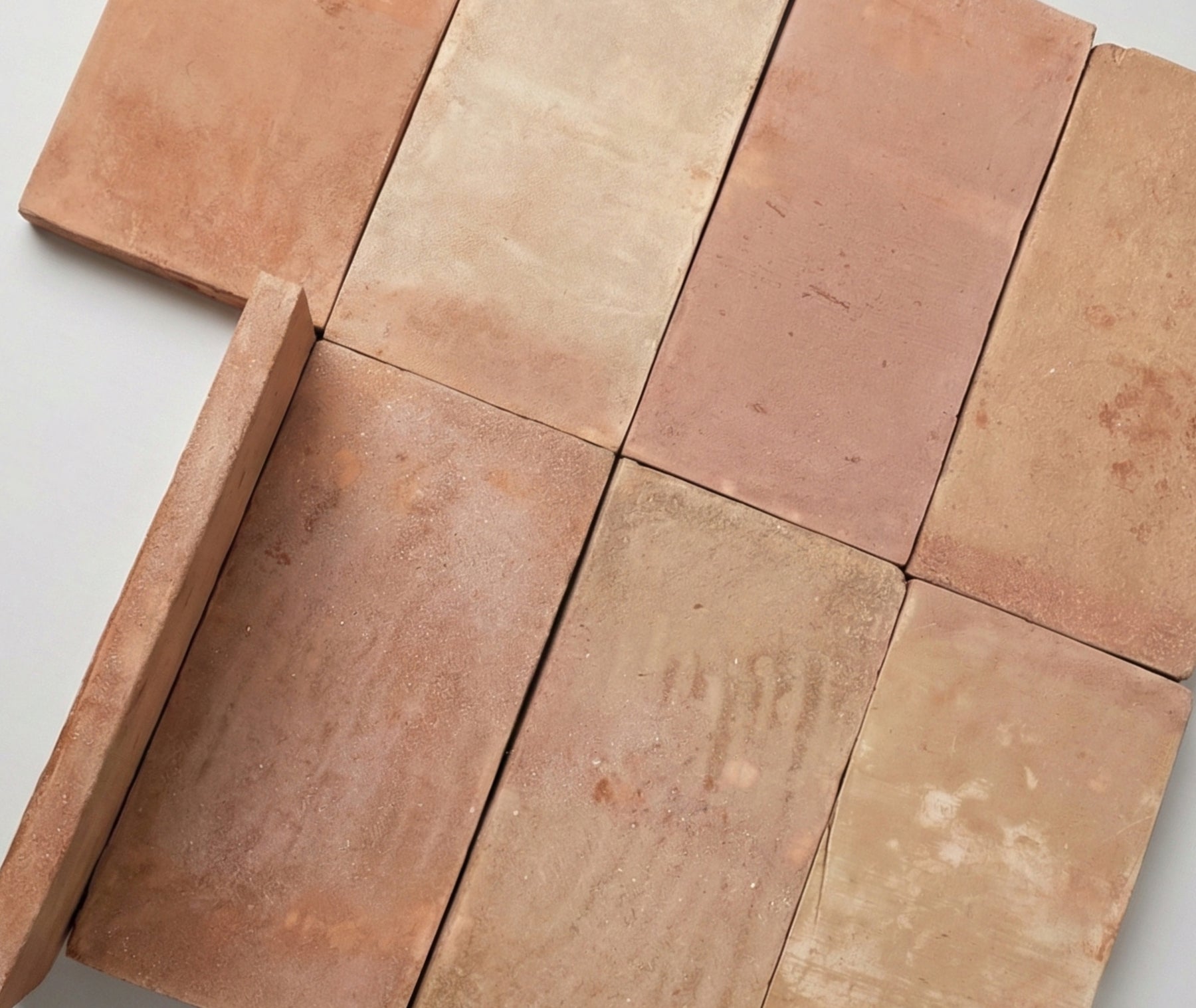 Terracotta tiles arranged in a pattern on a light gray background