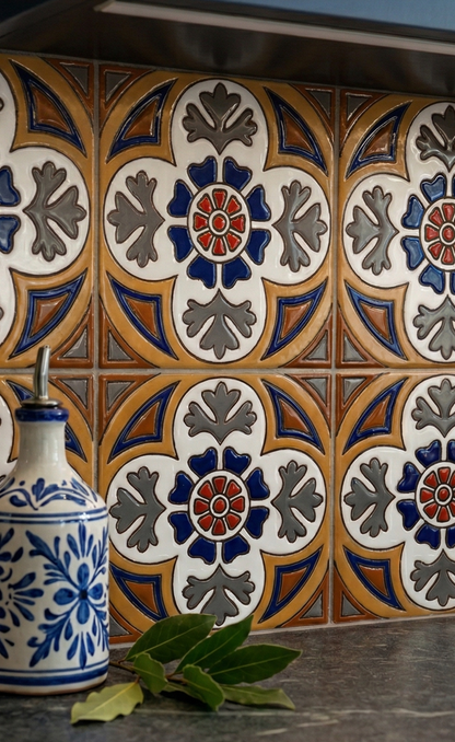 Glossy Relief Talavera tiles by Clay Imports with a repeating blue, red, grey, white, and gold floral pattern.