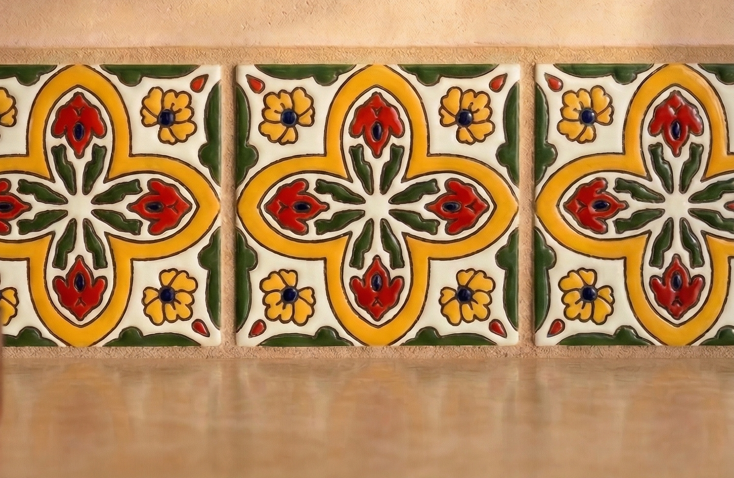 Relief Talavera tile by Clay Imports, with yellow, red, and green raised floral and foliage patterns.