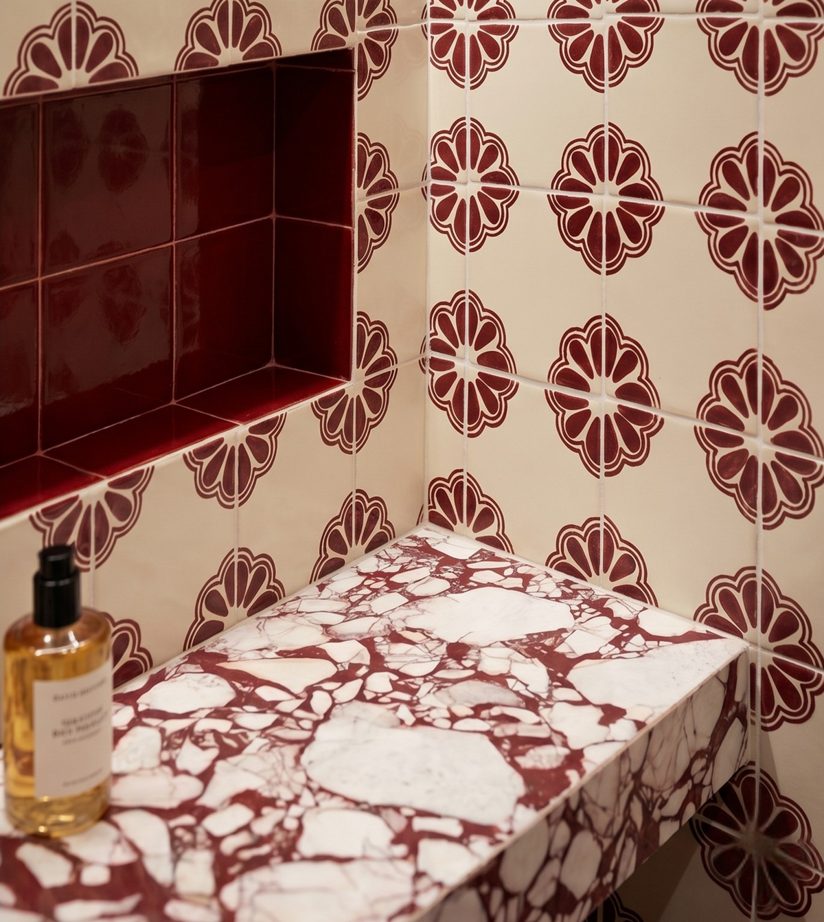 Marble-patterned shelf against a tiled wall with floral designs
