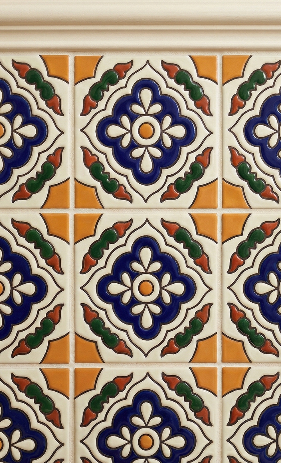 Relief Petunia 6x6 Talavera tile by Clay Imports with intricate blue, white, orange, and green floral relief patterns.