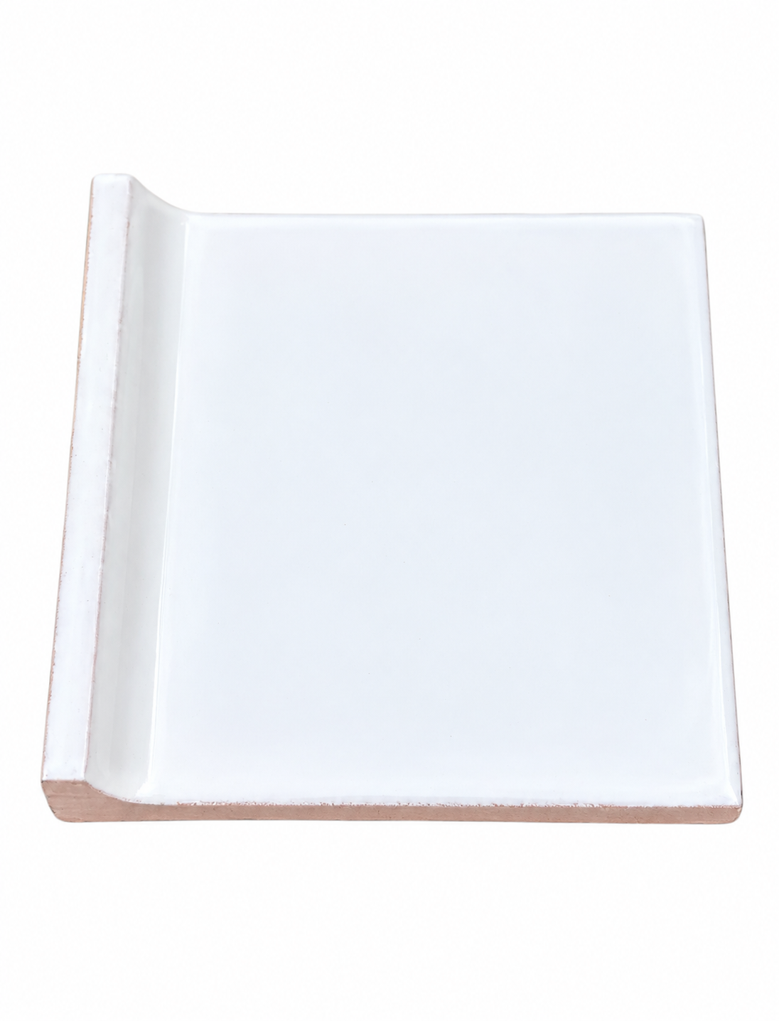 A glossy white ceramic tile features a raised bullnose edge on one side and a terracotta base.