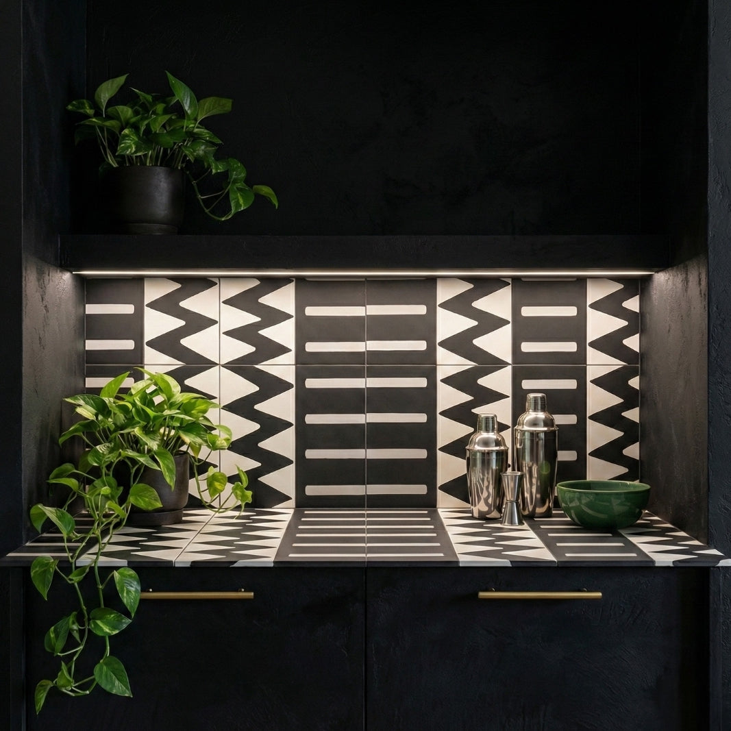 White and black Kente Vocho pattern tile from Clay Imports, featuring zigzag and horizontal stripe designs in a bar area.