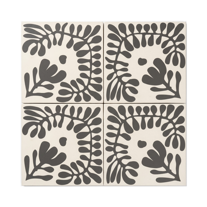 Pitch black Sprig Vocho pattern tile by Clay Imports, featuring a stylized botanical leaf design on a cream background.