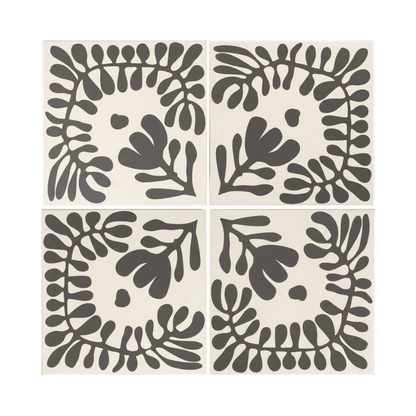 Four Pitch Black Sprig Vocho pattern tiles by Clay Imports, showing stylized organic leaves on an off-white background.