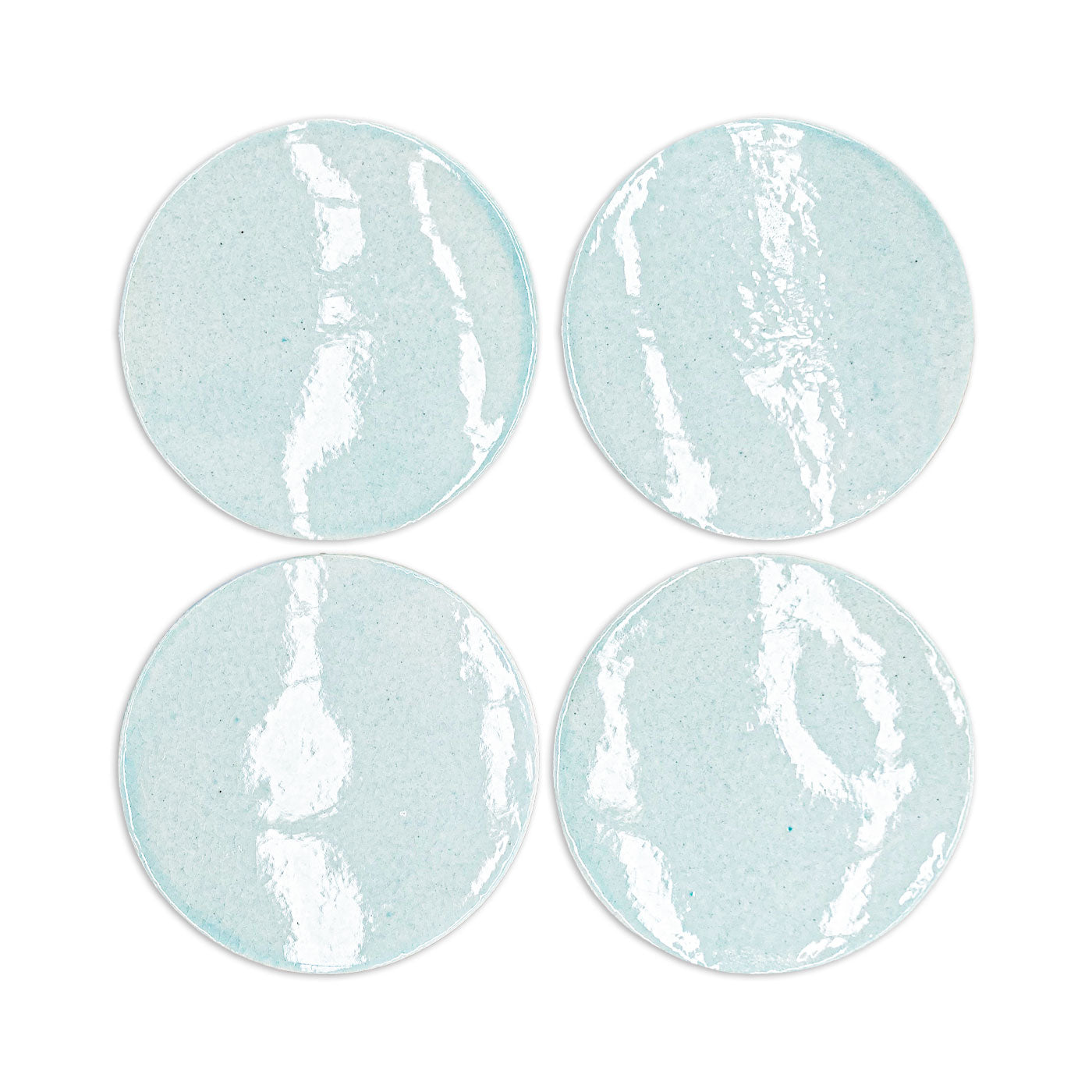 Light blue circular clay coasters with white crackle glaze, by Rombo & Circle, arranged in a grid, textured surface, handmade finish