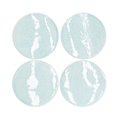 Light blue circular clay coasters with white crackle glaze, by Rombo & Circle, arranged in a grid, textured surface, handmade finish