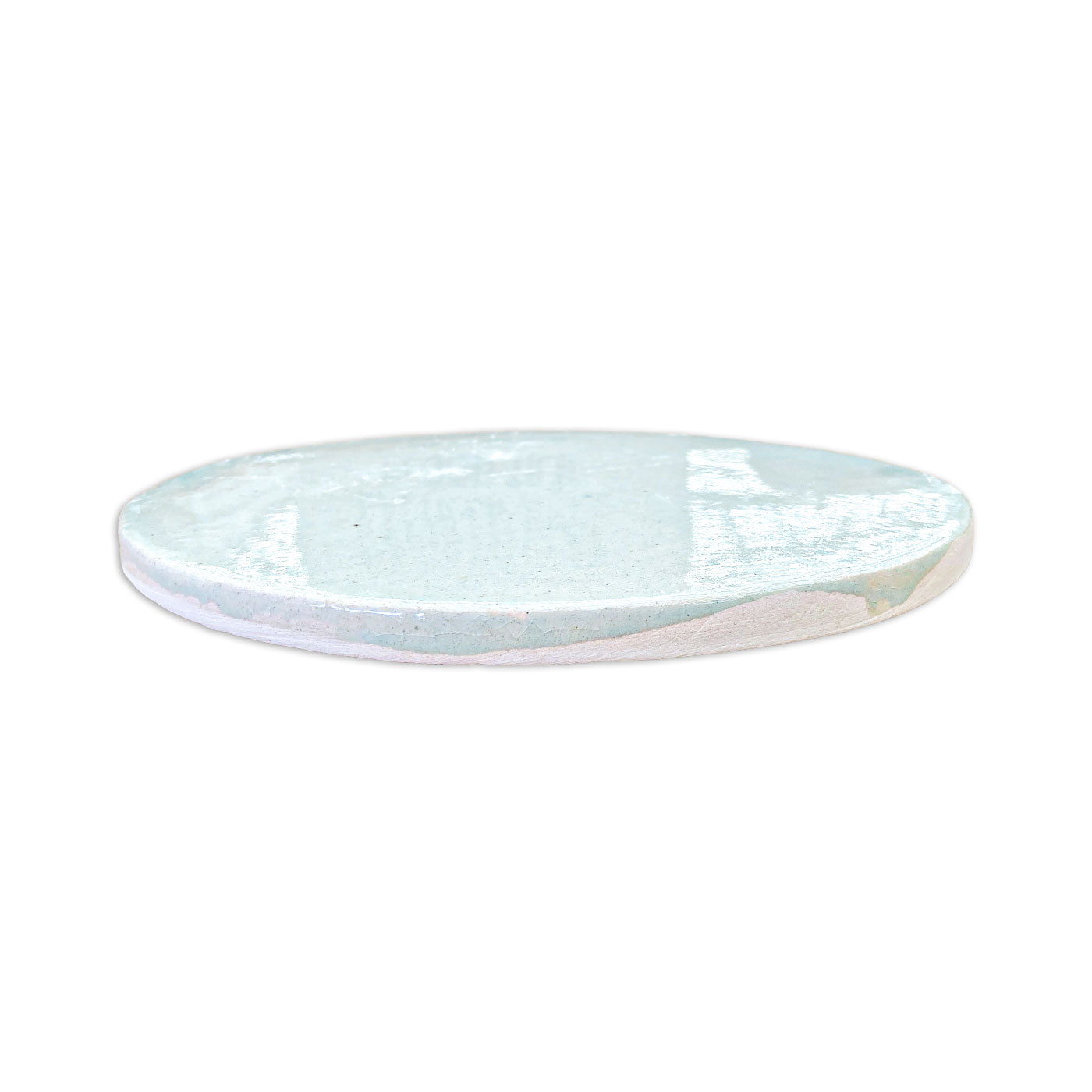 Circular light blue glazed ceramic plate with crackle texture and white rim, side view, from Rombo & Circle