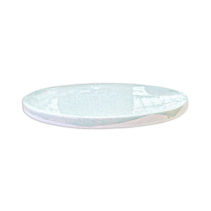Circular light blue glazed ceramic plate with crackle texture and white rim, side view, from Rombo & Circle