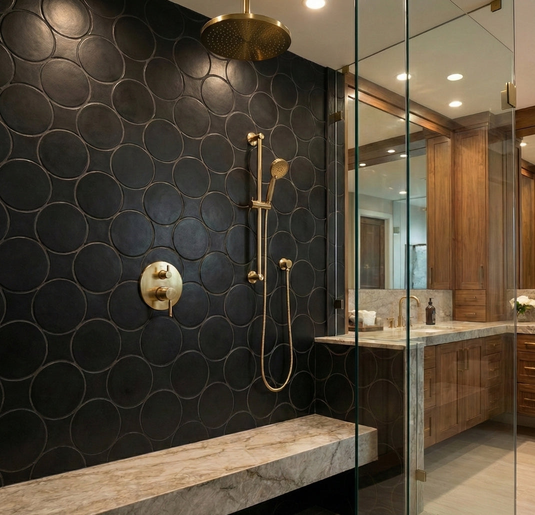 Black Suede Rombo & Circle solid tile by Clay Imports, forming a scalloped pattern on a shower wall with brass fixtures.