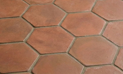 Umber Hexagon Cotto tiles by Clay Imports with a rustic, matte surface and light gray grout.