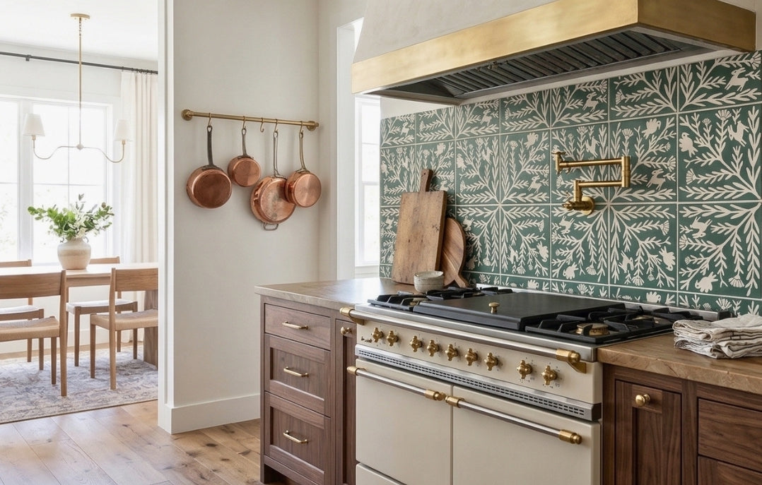Green and white Encanto Olivo pattern tile by Clay Imports installed as a kitchen backsplash with botanical and rabbit motifs.