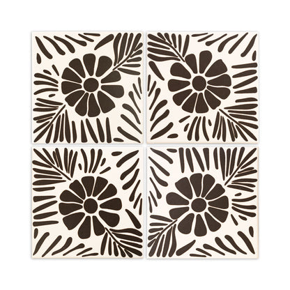 Four square off-white and dark brown tiles by Clay Imports, featuring a bold floral and leaf design.
