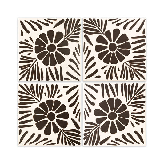 Four square off-white and dark brown tiles by Clay Imports, featuring a bold floral and leaf design.
