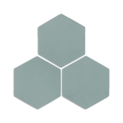 Three hexagon clay tiles in sage green by Clay Imports, arranged in a cluster with visible texture and subtle shadows.