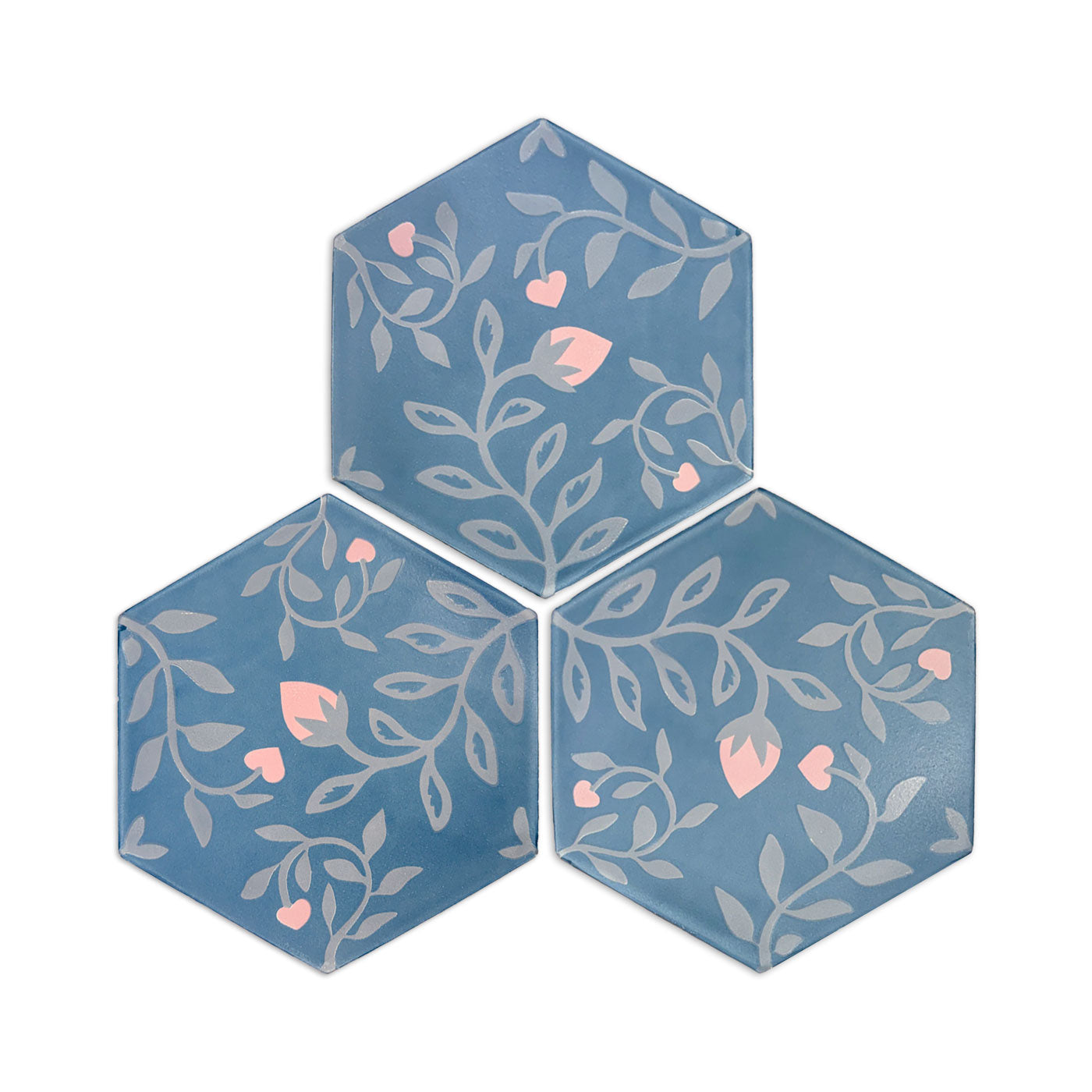 Three hexagonal tiles with floral pattern on a white background