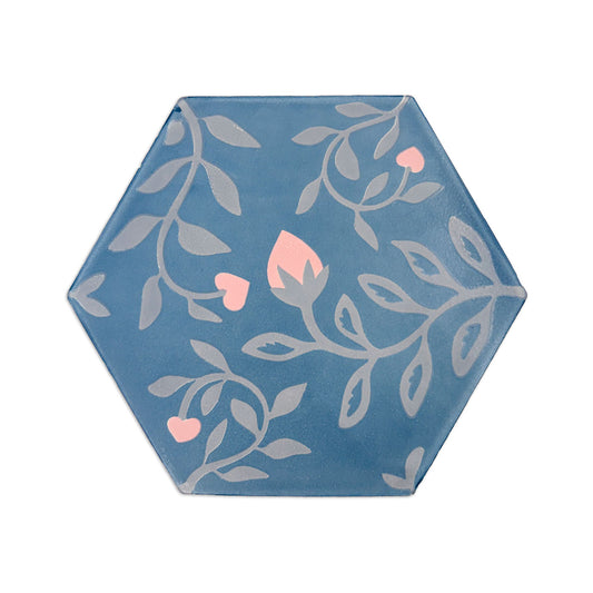 Midnight blue hexagonal pattern tile by Clay Imports with grey floral vines, pink hearts, and a flower bud.