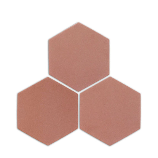 Pink granite hexagon clay tile by Clay Imports, three pieces showing a speckled, matte texture on a white background.