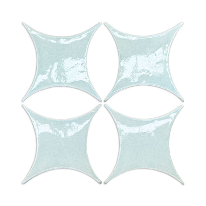Light blue crackle-glazed ceramic tiles in star shape, set of four, by Rombo & Circle, glossy textured surface, top-down view