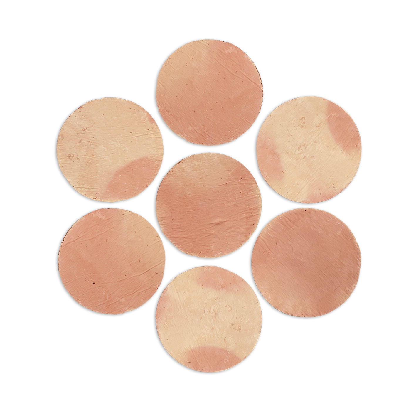 Antique matte terracotta penny tiles by Clay Imports, arranged in a flower shape with varied reddish-brown tones and subtle texture on a white background.