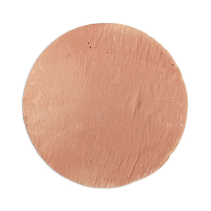 Antique matte reddish-brown round terracotta tile by Clay Imports with a rustic texture and uneven edges, top-down view.