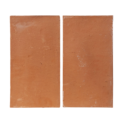 Two reddish-brown terracotta Baked Thin Pavers by Clay Imports, with a rustic, unglazed texture, placed side-by-side.