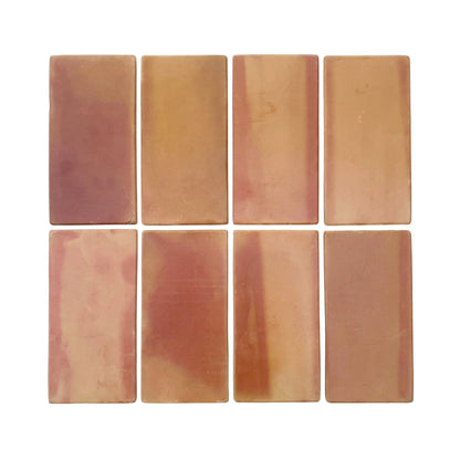 Rounded terracotta tiles by Clay Imports in varied reddish-brown and beige tones, arranged in a grid.